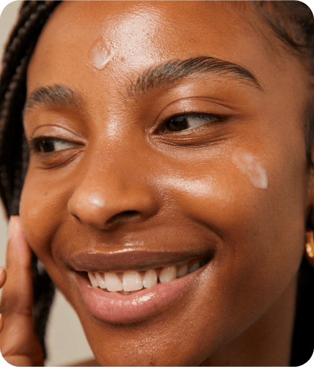 Close up image of smiling woman applying skincare AI Skincare